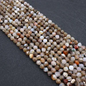 Macro detail of faceted natural striped agate beads in earthy tones for DIY jewelry making