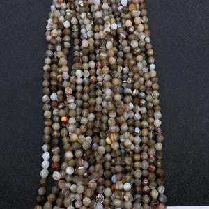 Macro shot of faceted striped agate beads showing natural textures on black background