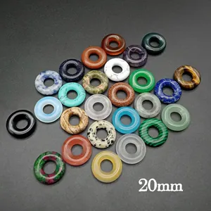 Detailed view of 20mm natural stone donut beads in malachite and assorted gems
