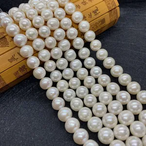 Macro detail of high-quality white round freshwater pearls on a bamboo scroll