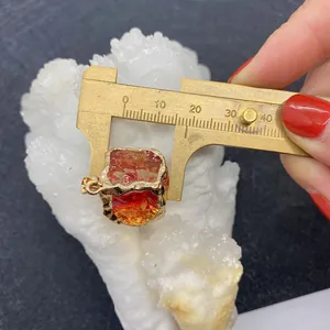 Detail showing the 17.5mm measurement of the red natural stone cube pendant with gold bezel