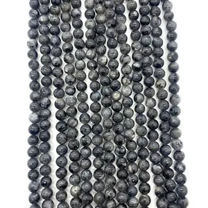 Detailed view of natural black flash stone beads with shimmering iridescent luster