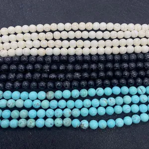 Macro detail of round turquoise beads in white, black and blue with natural stone texture