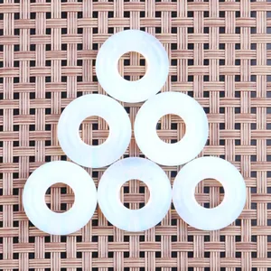 Detailed view of six flat donut opal stones with smooth finish on a natural texture background