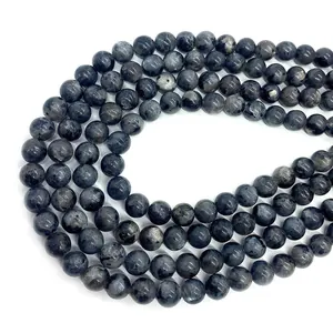 Detailed view of polished labradorite beads with distinct blue and gold flashes of light