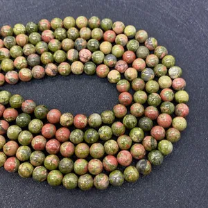 Macro shot of polished 8mm natural green unakite stone beads for jewelry making