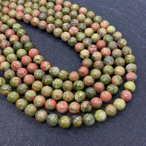 Macro detail of natural Unakite round beads showing green and pink mineral textures