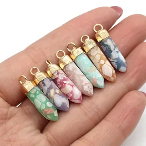 Close-up of seven colorful hexagonal crushed stone pendants with gold metal caps