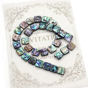 Macro view of square abalone shell beads with natural iridescent colors for DIY jewelry