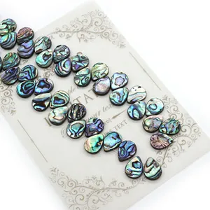 Close-up of teardrop-shaped natural abalone shell loose beads with rainbow luster for DIY