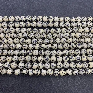 Detailed close-up of natural Dalmatian Stone round beads for DIY jewelry making