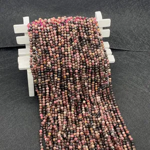 Macro shot of 2-4mm faceted natural rhodonite beads with pink and black textures