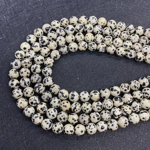 Macro detail of natural round Dalmatian Jasper beads for DIY jewelry making