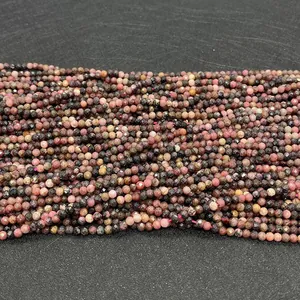 Close-up of 2-4mm faceted natural black-line rhodochrosite round beads for DIY jewelry