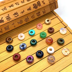 Macro shot of colorful stone spacer beads with large holes arranged on a bamboo mat