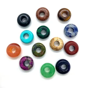 Assorted natural gemstone donuts including tiger eye, malachite, and agate for jewelry making