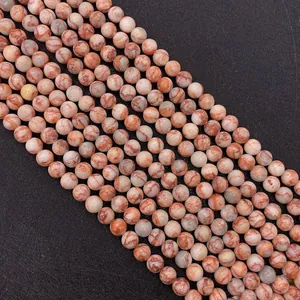 Macro shot of 6mm-10mm red network stone round beads with natural polished textures
