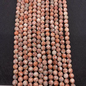 Close-up of natural red network stone beads with white marble texture for jewelry DIY
