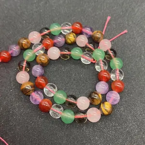 Macro shot of colorful 6-10mm natural crystal beads including tiger eye and amethyst