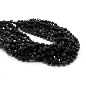 Macro view of faceted black onyx gemstone beads showing detailed geometric cutting