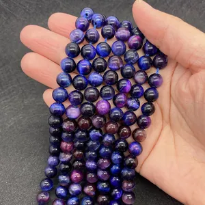 Close-up of purple and blue tiger eye beads showing natural cat-eye effect and texture