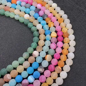 Macro shot of matte natural agate beads showing vibrant colors and frosted texture