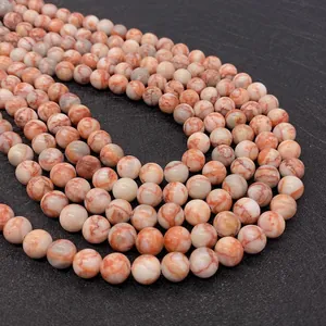 Macro view of polished round red network stone beads for DIY jewelry making