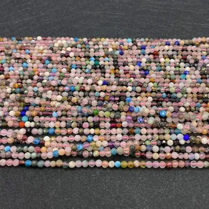 Macro shot of colorful 2-3mm faceted natural stone beads on a pink silk thread
