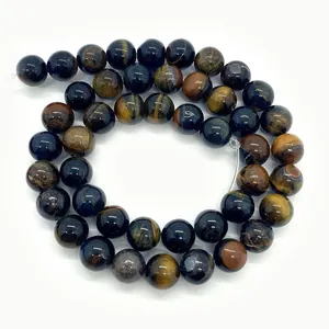 Macro view of polished tiger eye stone beads in blue and gold with cat eye effect