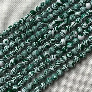 Macro shot of natural malachite beads with unique green and white striped texture
