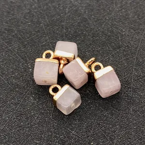 Detail of pink crystal cube pendants with gold plated bail hooks for jewelry making