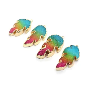 Macro detail of rainbow crystal leaf pendants with golden edges and metallic loop