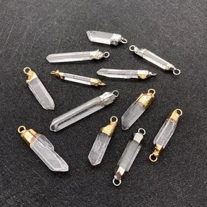 Macro detail of natural clear quartz pendants with gold and silver metal caps for DIY jewelry