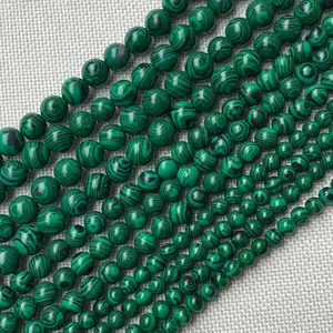 Natural malachite round beads in various sizes featuring unique green banded textures