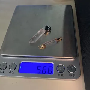 Detailed scale view showing a combined weight of 5.68g for crystal stone pendants