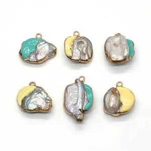 Detail view of Baroque shell pendants with gold edges and mint green enamel finish