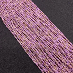 Macro detail of faceted natural purple lepidolite round beads for DIY jewelry making