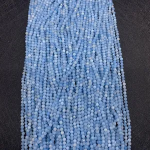 Close-up of faceted natural apatite gemstone beads in light blue for DIY jewelry