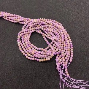Close-up of faceted natural purple lepidolite round beads for DIY jewelry making