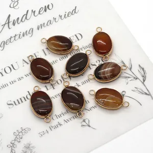 Detailed view of eight oval agate connectors with gold metal edges and double rings