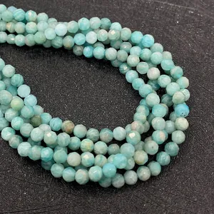 Detailed view of faceted natural amazonite round beads with light blue-green tones