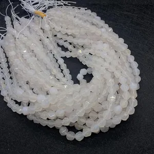 Macro detail of faceted white agate beads showing geometric cuts and milky luster