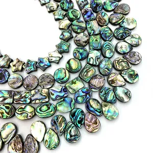 Natural abalone shell beads in various shapes with iridescent blue-green rainbow shimmer