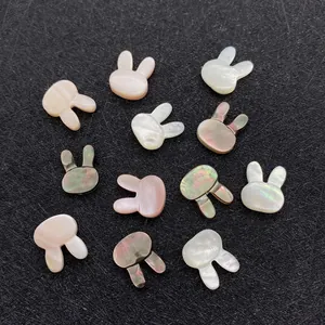 Detailed macro shot of 10x12mm rabbit-shaped natural shell beads with iridescent luster
