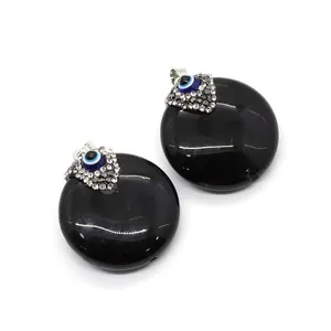 Anhänger aus schwarzem Achat mit glitzernden Strasssteinen und blauem Evil-Eye-Detail