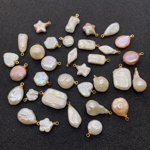 Macro view of assorted baroque pearl pendants in heart and star shapes with gold loops