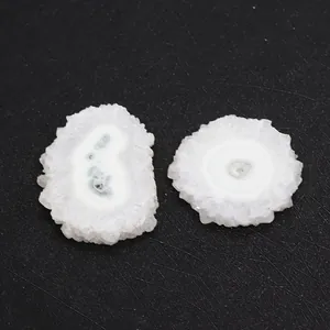 Macro view of polished white solar quartz slices with natural grey circular crystal patterns