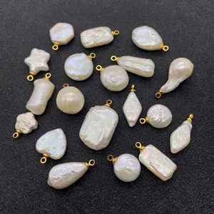Assorted natural freshwater baroque pearl charms with gold loops in various shapes on black