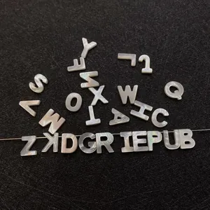 Macro shot of natural white mother of pearl alphabet beads for DIY jewelry making