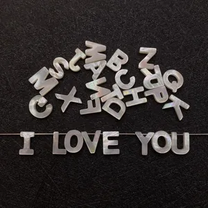 Macro detail of natural mother of pearl alphabet beads for DIY jewelry making